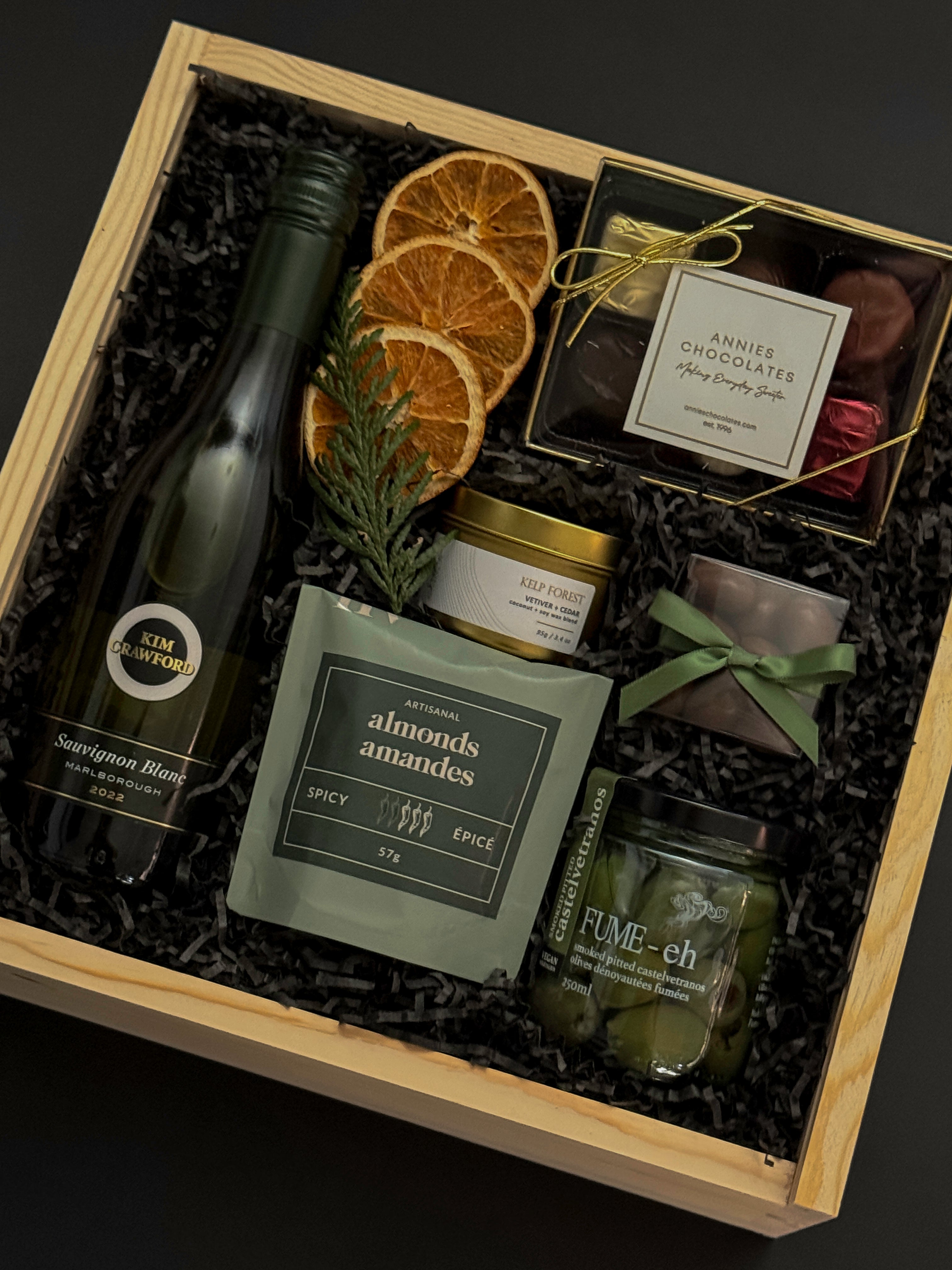 Corporate wine gift box with Kim Crawford Sauvignon Blanc, artisan foods, and festive accents.