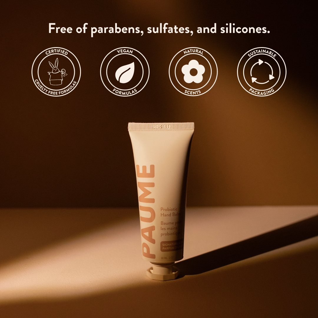 PAUME hand balm tube with sustainability icons on a brown background