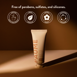 PAUME hand balm tube with sustainability icons on a brown background