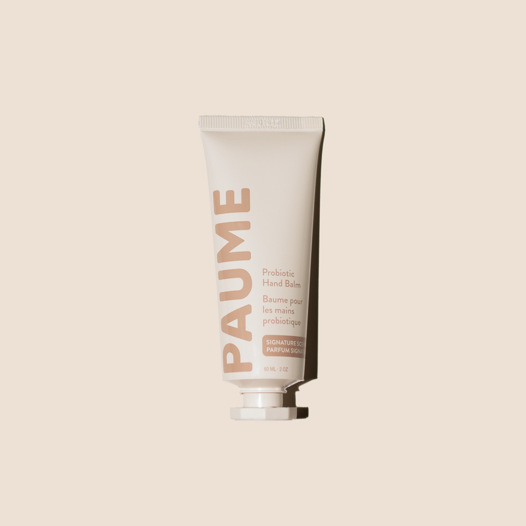 PAUME hand balm tube on a beige background
