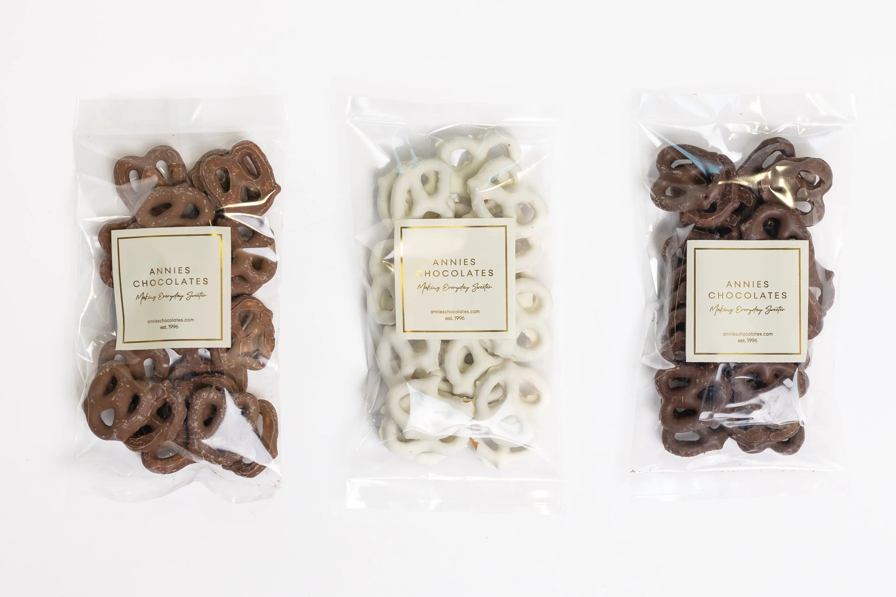 Three packages of Annie's Chocolates on a white background