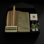 Hestia housewarming gift box featuring an acacia wood board, Aēsop soap, green tea towel, artisan olive oil, balsamic vinegar and dipping dish.