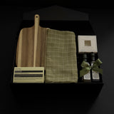 Hestia housewarming gift box featuring an acacia wood board, Aēsop soap, green tea towel, artisan olive oil, balsamic vinegar and dipping dish.