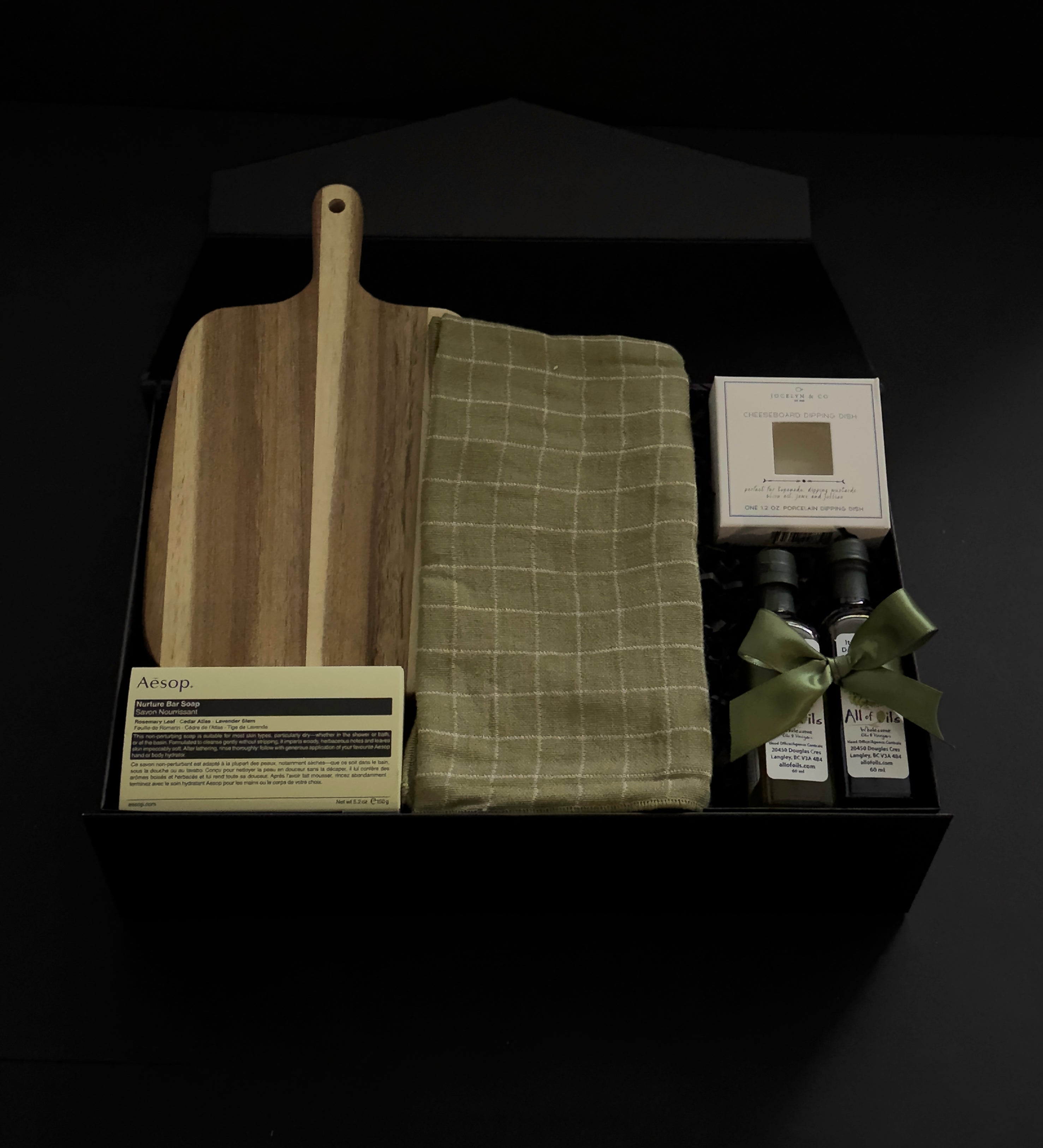 Hestia housewarming gift box featuring an acacia wood board, Aēsop soap, green tea towel, artisan olive oil, balsamic vinegar and dipping dish.