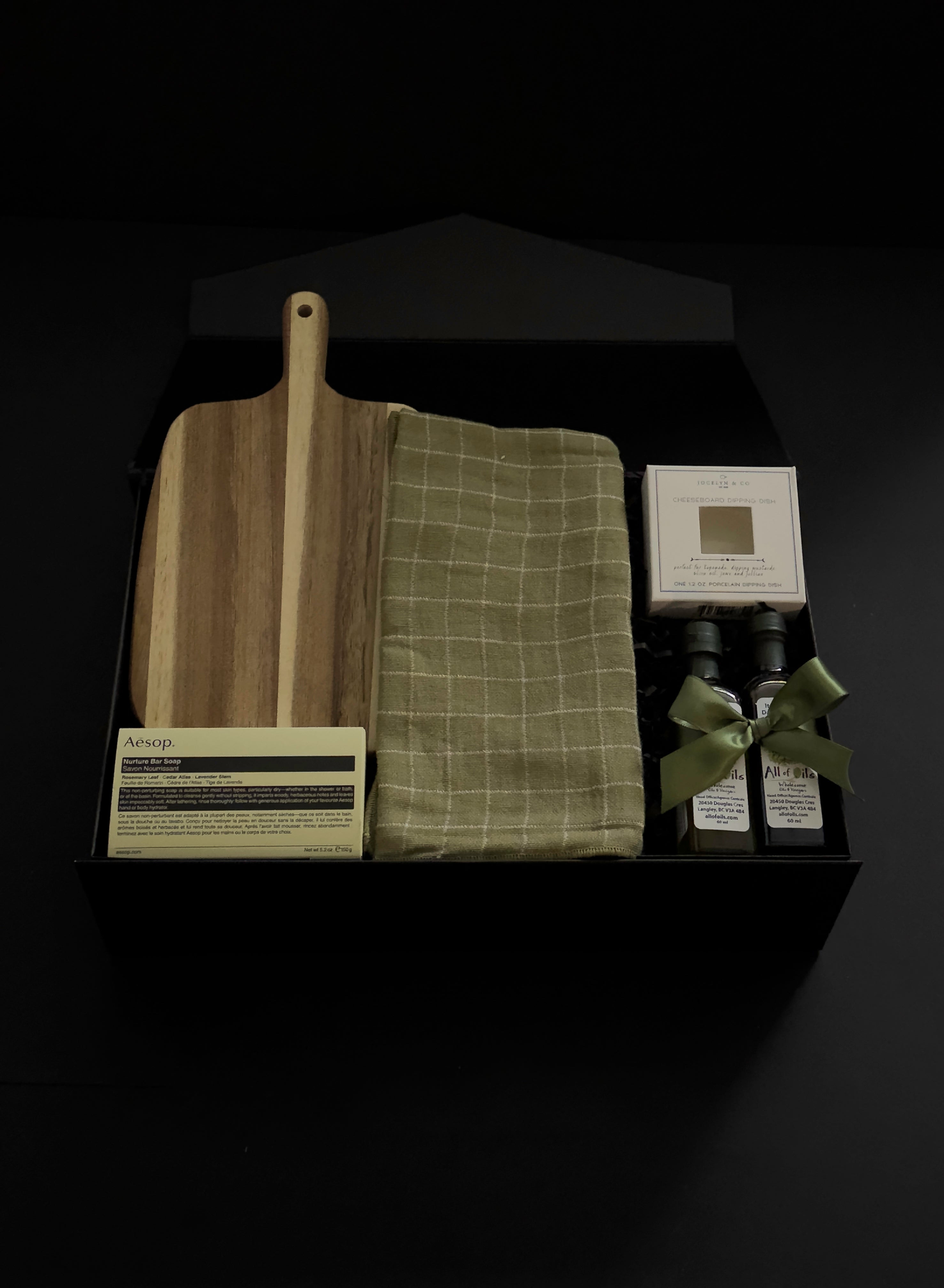 Hestia housewarming gift box featuring an acacia wood board, Aēsop soap, green tea towel, artisan olive oil, balsamic vinegar and dipping dish.
