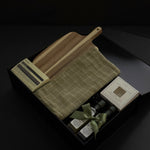 Open black Hestia realtor closing gift box with Aēsop soap, acacia wood board, green plaid tea towel, olive oil and balsamic vinegar by Muse Baskets and Co.