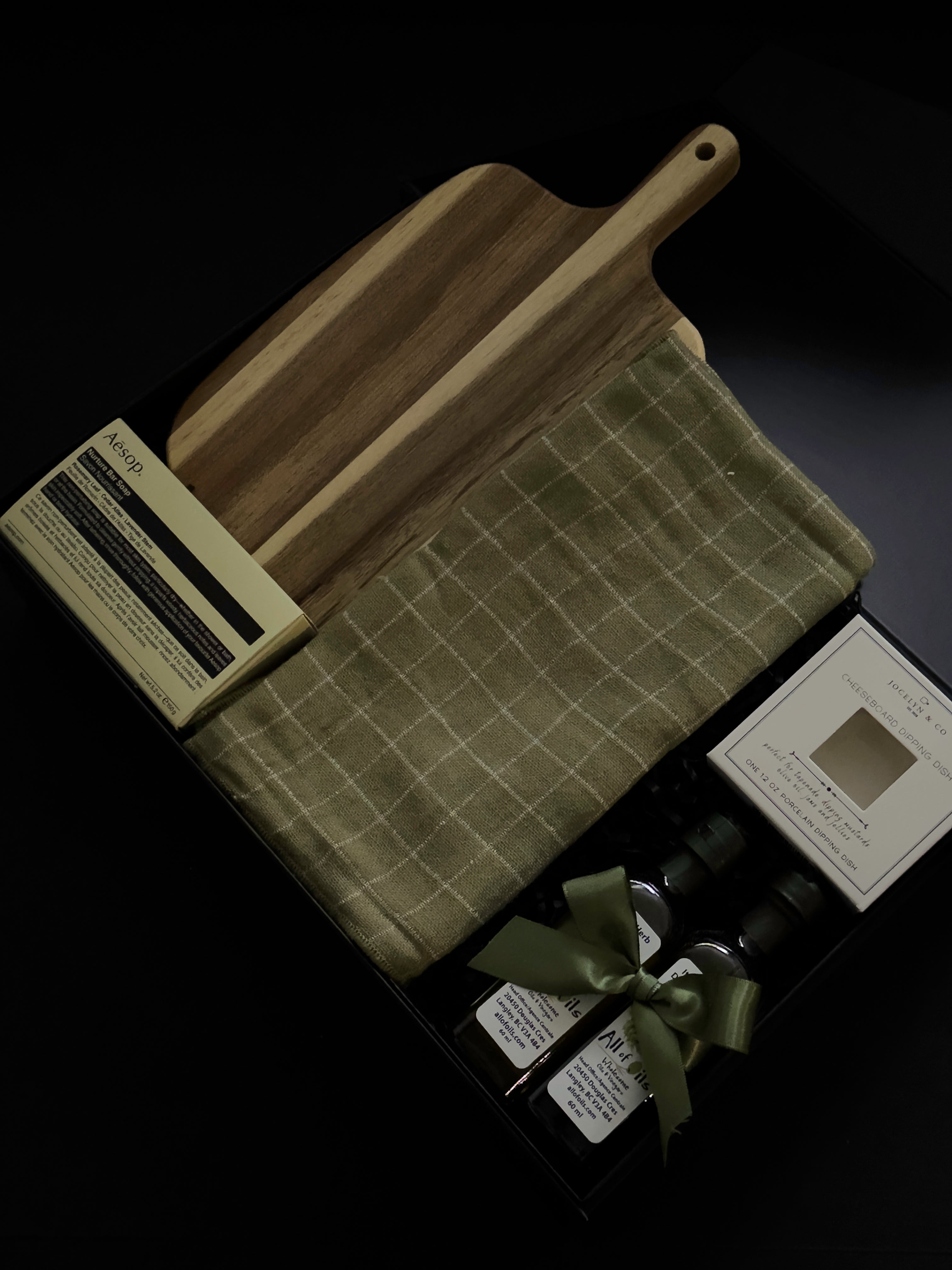 Luxury realtor closing gift box by Muse Baskets and Co. with Aēsop soap, acacia board, tea towel, olive oil and balsamic vinegar for a new homeowner.