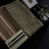 Hestia possession day gift box in black packaging with home and kitchen pieces, including Aēsop soap, acacia wood board, olive oil and balsamic vinegar.