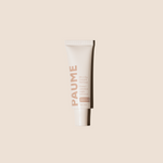 White tube of PAUME cream on a beige background