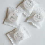 Aqua Studio shower steamer packets in Flower Temple, Hinoki, Menthol Eucalyptus, and Sweet Dreams scents, a self-care product featured in Muse Baskets and Co. gift baskets
