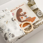 Luxury new baby gift box by Muse Baskets and Co. featuring a Loulou Lollipop swaddle and baby accessories with Canadian-made body care for a new mother.