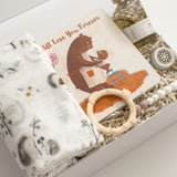 Luxury new baby gift box by Muse Baskets and Co. featuring a Loulou Lollipop swaddle and baby accessories with Canadian-made body care for a new mother.