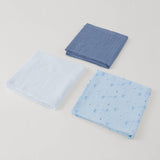 Three folded blue fabric swaddles on a light gray background