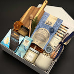 Fireside Provisions client appreciation gift by Muse Baskets and Co., with a soy candle, stoneware tea cup and chocolate in a Signature Pearl White gift box.