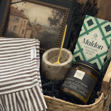 Woven housewarming gift basket with Canadian-made home accents, acacia serving board, Maldon salt, marble salt cellar and Hearth & Home candle by Muse Baskets and Co.
