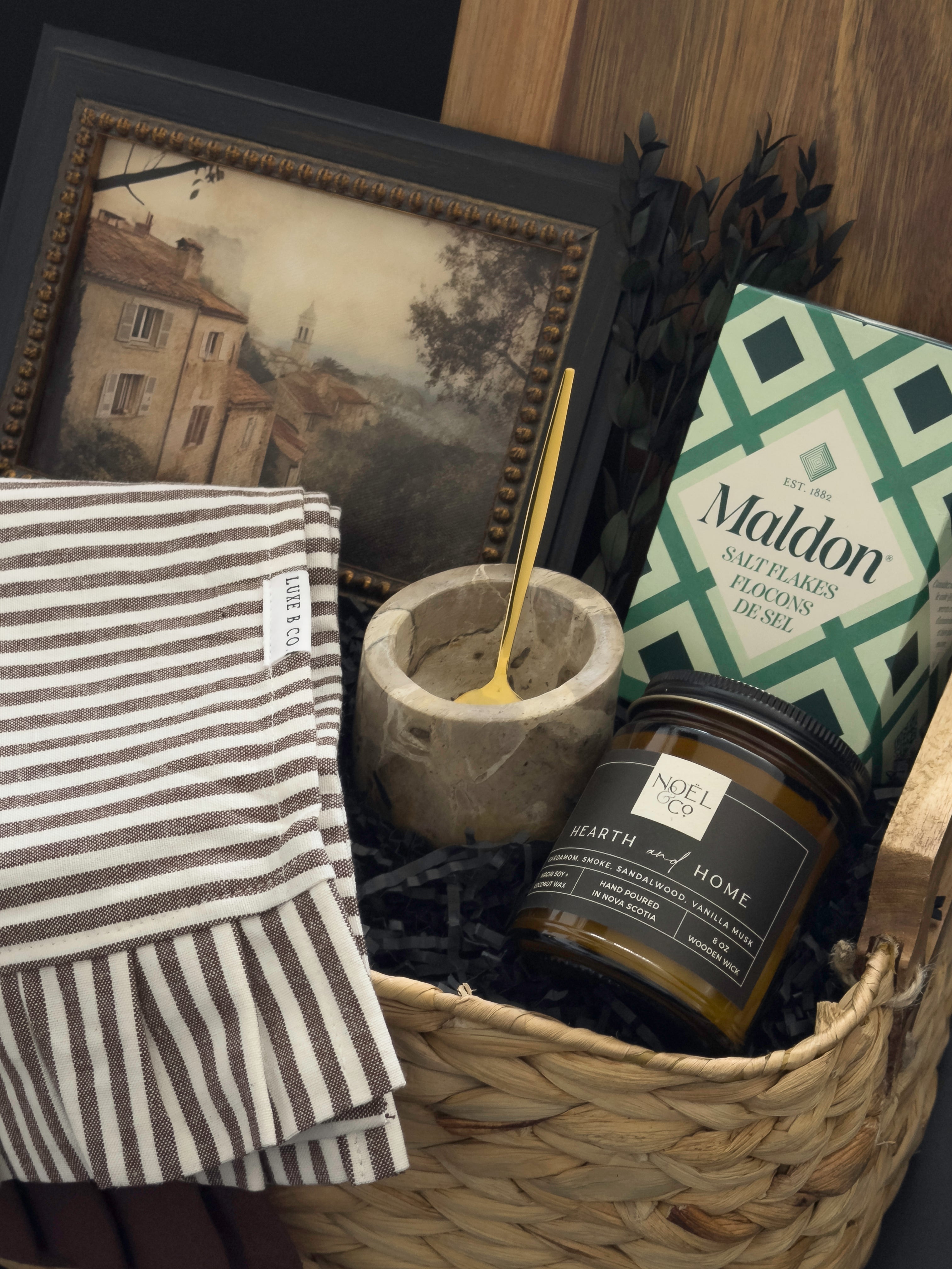 Woven housewarming gift basket with Canadian-made home accents, acacia serving board, Maldon salt, marble salt cellar and Hearth & Home candle by Muse Baskets and Co.