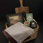 Hearth and Home realtor closing gift basket with acacia wood board, framed European artwork, marble salt cellar, striped kitchen towel and candle by Muse Baskets and Co.