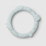 Light blue silicone teething ring on a light gray background