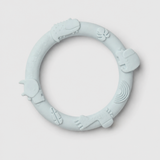 Light blue silicone teething ring on a light gray background