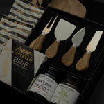 side view of Charcuterie Maison gift box featuring Gharyan Stoneware olive wood board and Provisions Food Company jams