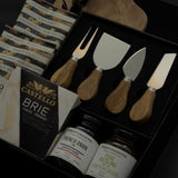 side view of Charcuterie Maison gift box featuring Gharyan Stoneware olive wood board and Provisions Food Company jams