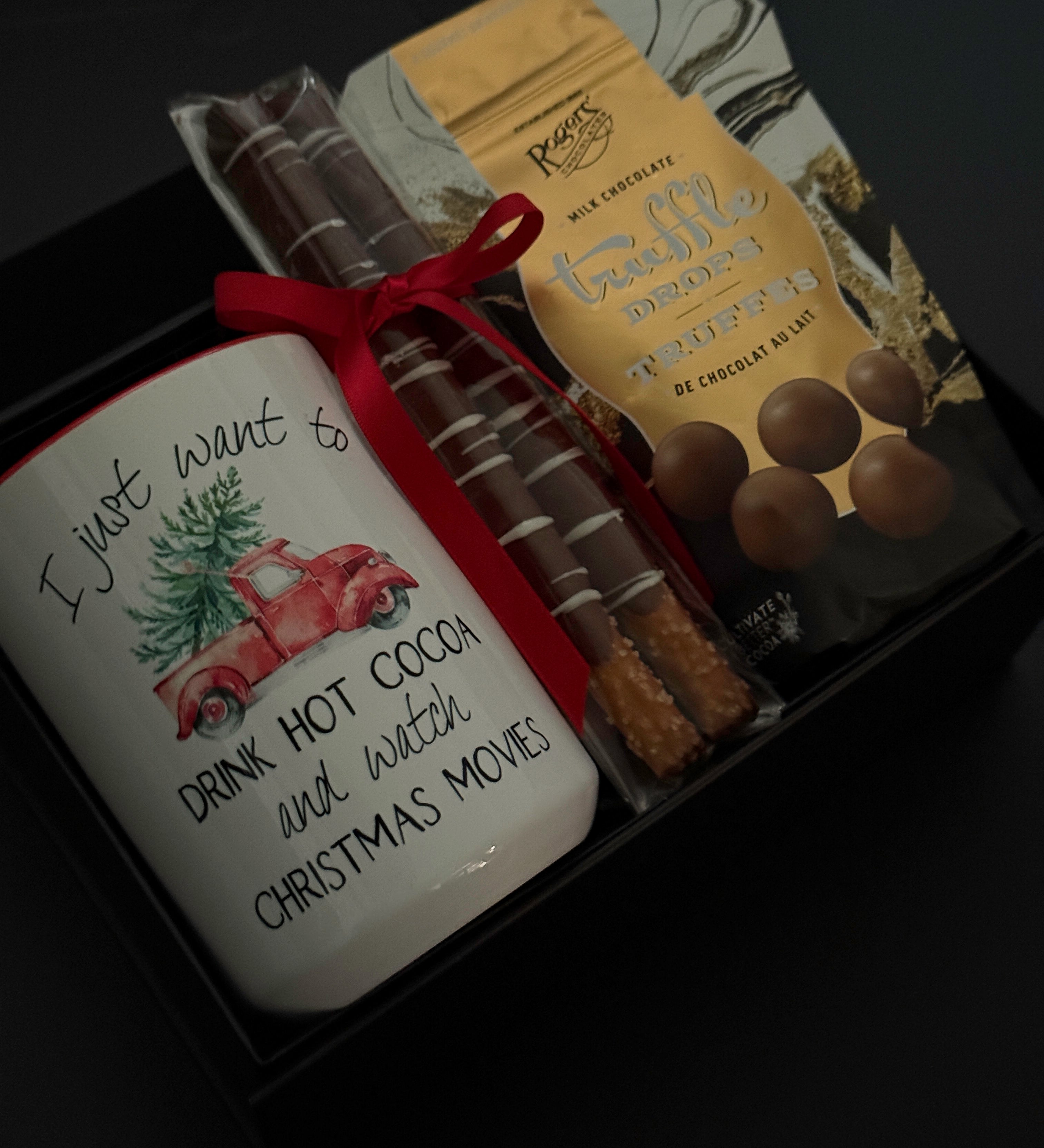 Teacher holiday gift box with hot chocolate truffle drops, chocolate pretzels, and mug.