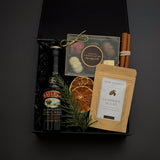 The Parlour Christmas gift box by Muse Baskets and Co. arranged with Baileys, gourmet chocolates, classic hot chocolate, cinnamon sticks and seasonal greenery.