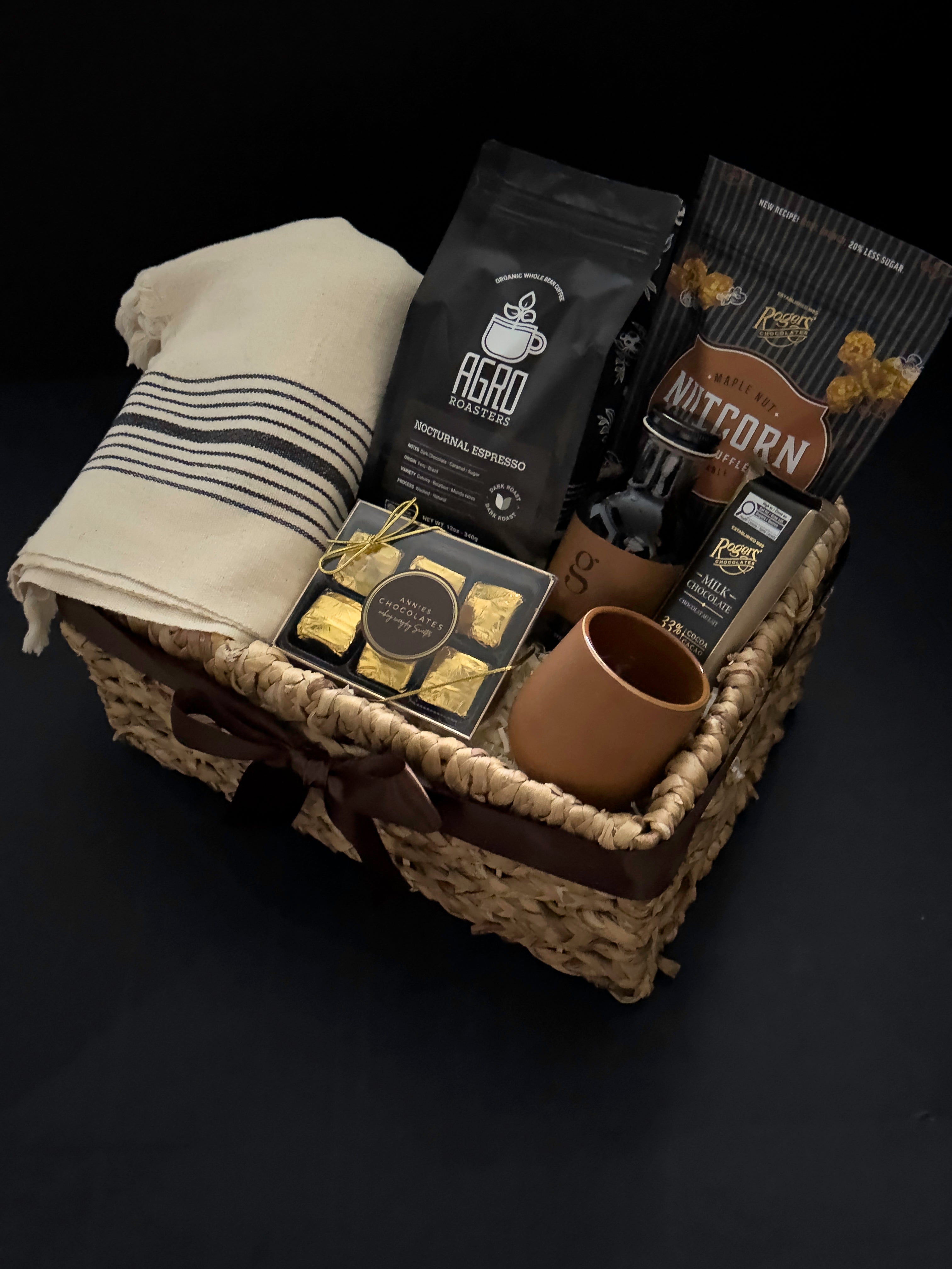 Close up of Maison Café gift basket featuring handmade terracotta stoneware cup Nocturnal Espresso and Annie's Chocolates