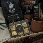Close up of Maison Café gift basket featuring handmade terracotta stoneware cup Nocturnal Espresso and Brown Sugar Syrup