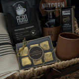 Close up of Maison Café gift basket featuring handmade terracotta stoneware cup Nocturnal Espresso and Brown Sugar Syrup