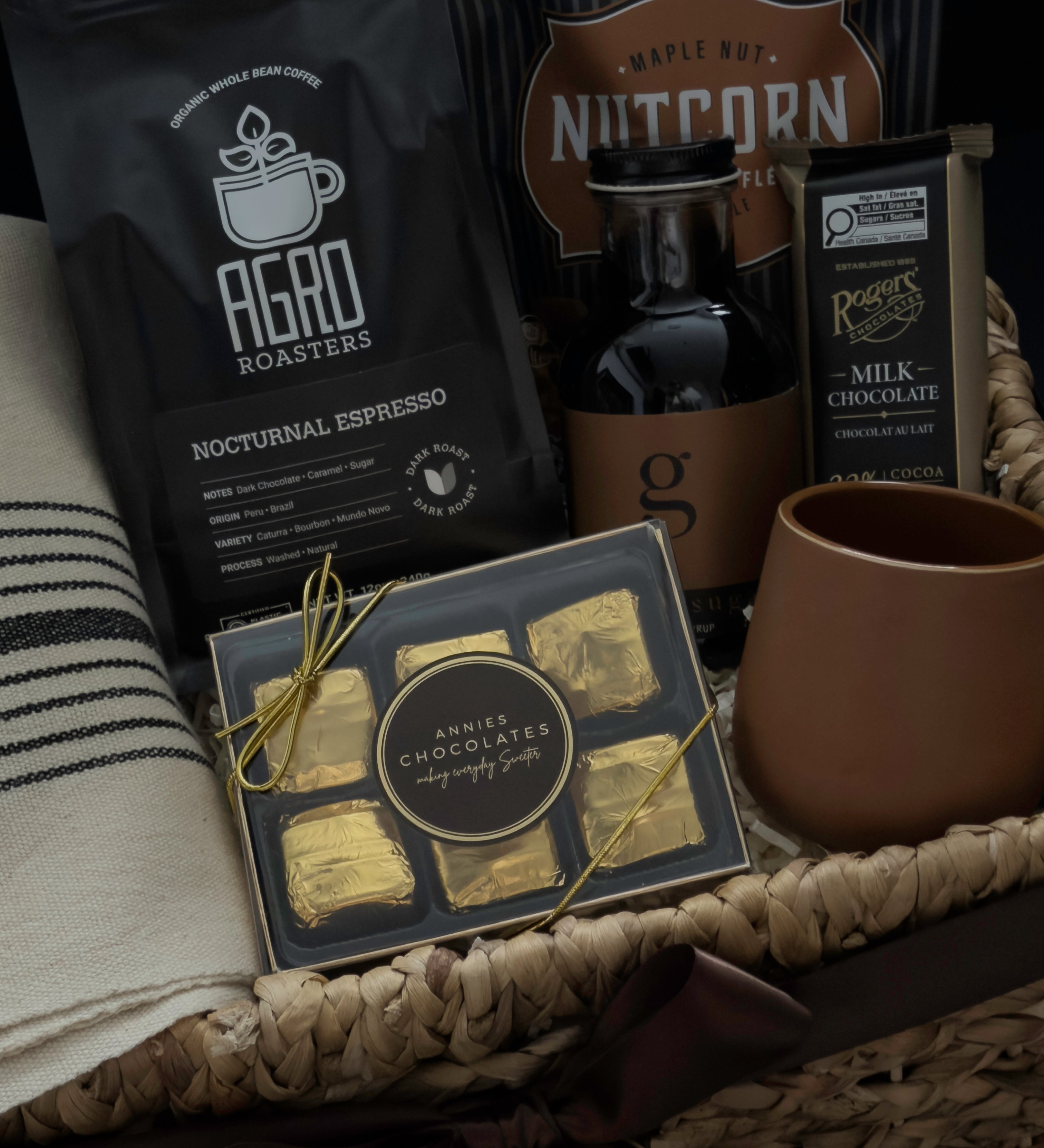 Close up of Maison Café gift basket featuring handmade terracotta stoneware cup Nocturnal Espresso and Brown Sugar Syrup