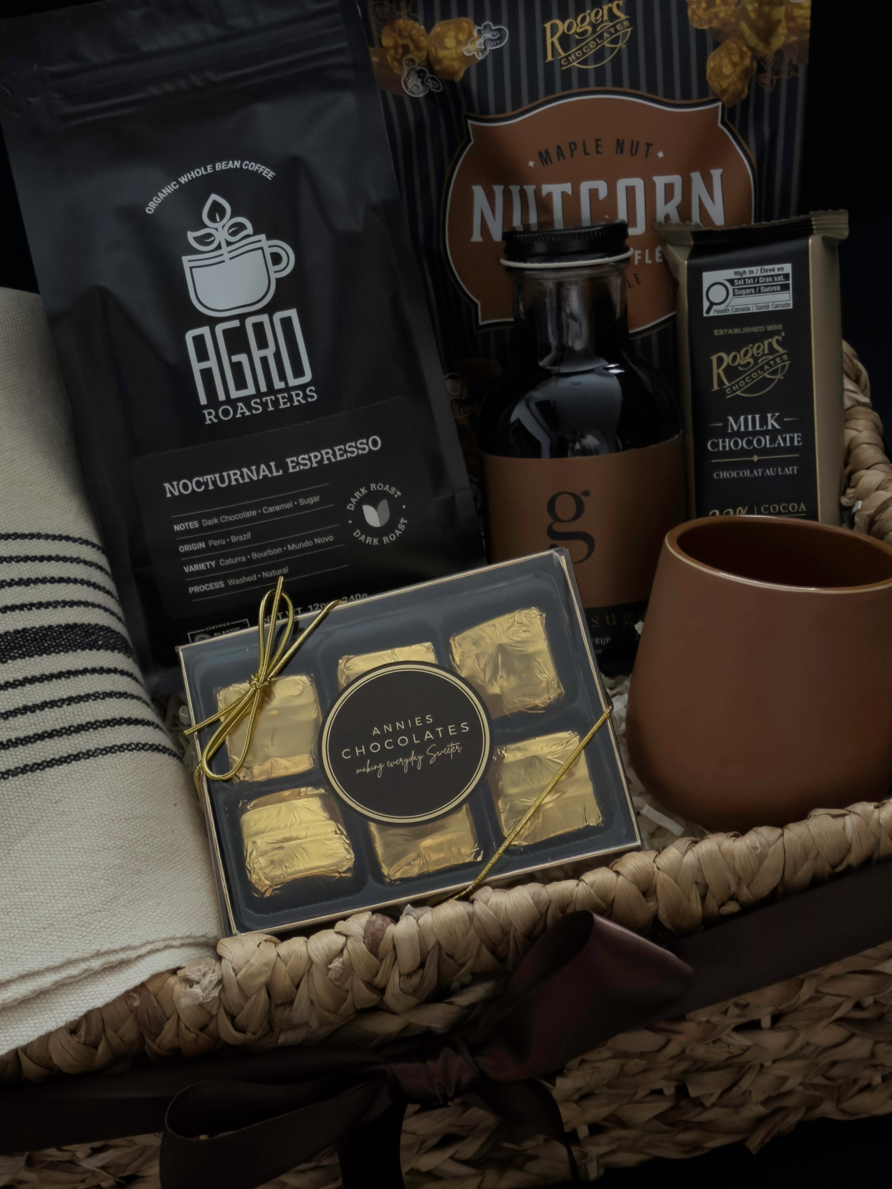 Close up of Maison Café gift basket featuring handmade terracotta stoneware cup Nocturnal Espresso and Brown Sugar Syrup