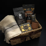Side angle of luxury Canadian coffee gift basket with brown satin ribbon MOA Turkish towel and Roger's Chocolates by Muse Baskets and Co