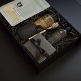A luxe Solenne gift box arranged with artisanal coffee, honey, stoneware mug, maple syrup, and pâté on a soft neutral backdrop.