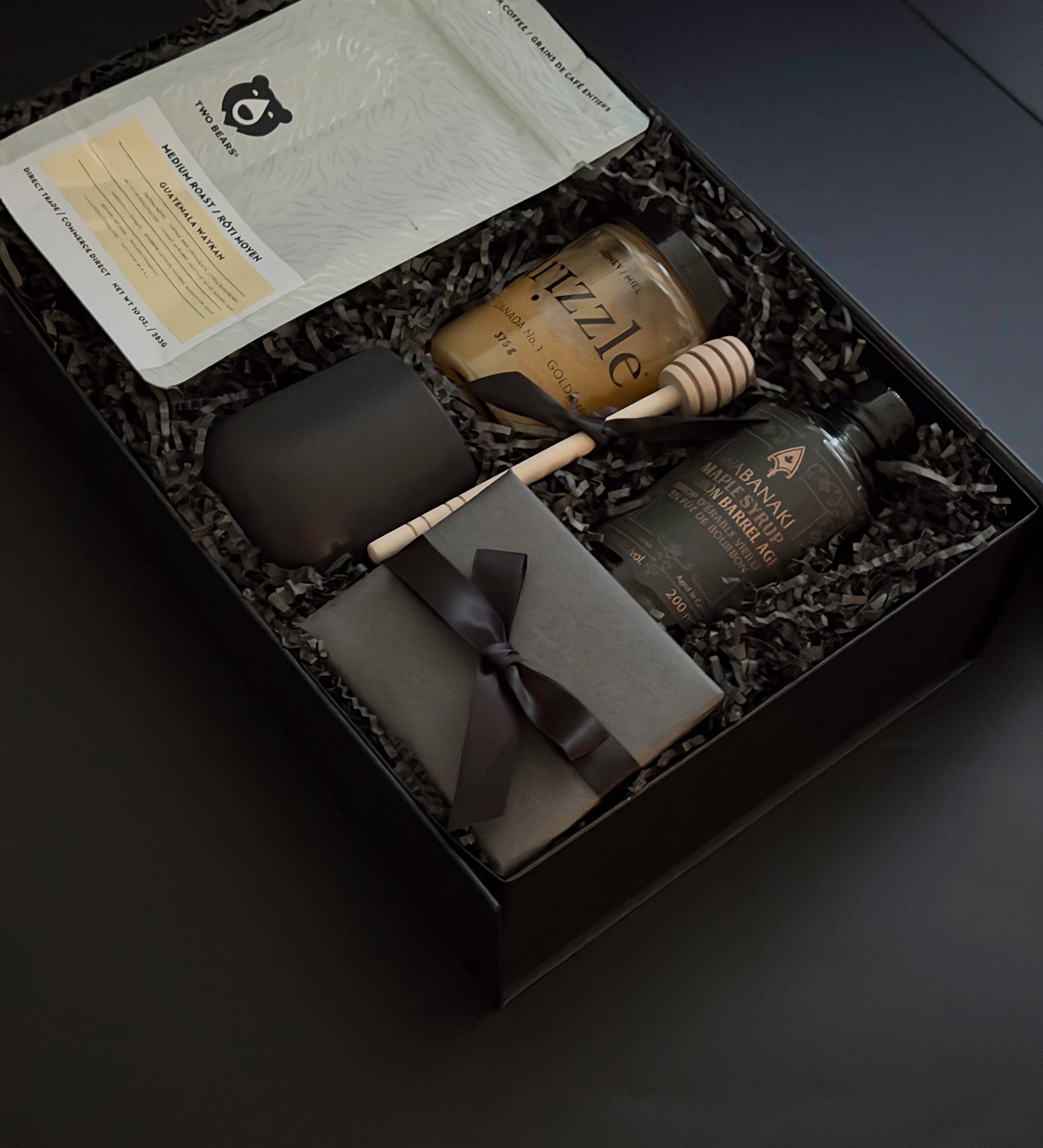 A luxe Solenne gift box arranged with artisanal coffee, honey, stoneware mug, maple syrup, and pâté on a soft neutral backdrop.