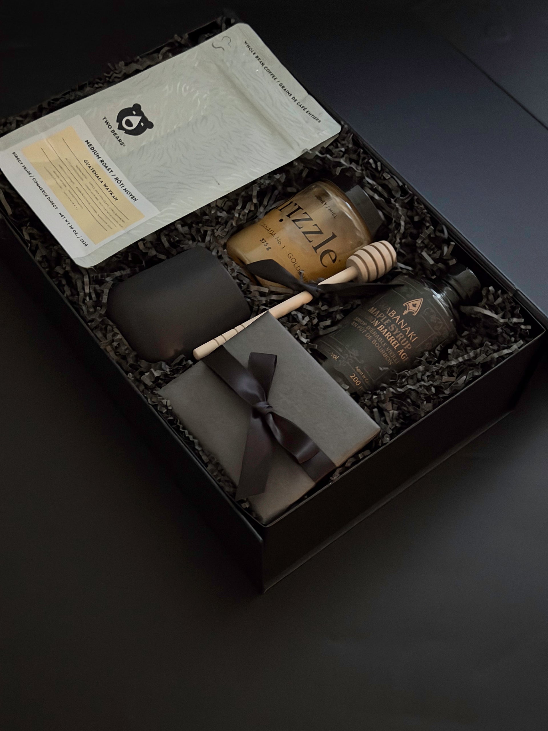 A luxe Solenne gift box arranged with artisanal coffee, honey, stoneware mug, maple syrup, and pâté on a soft neutral backdrop.