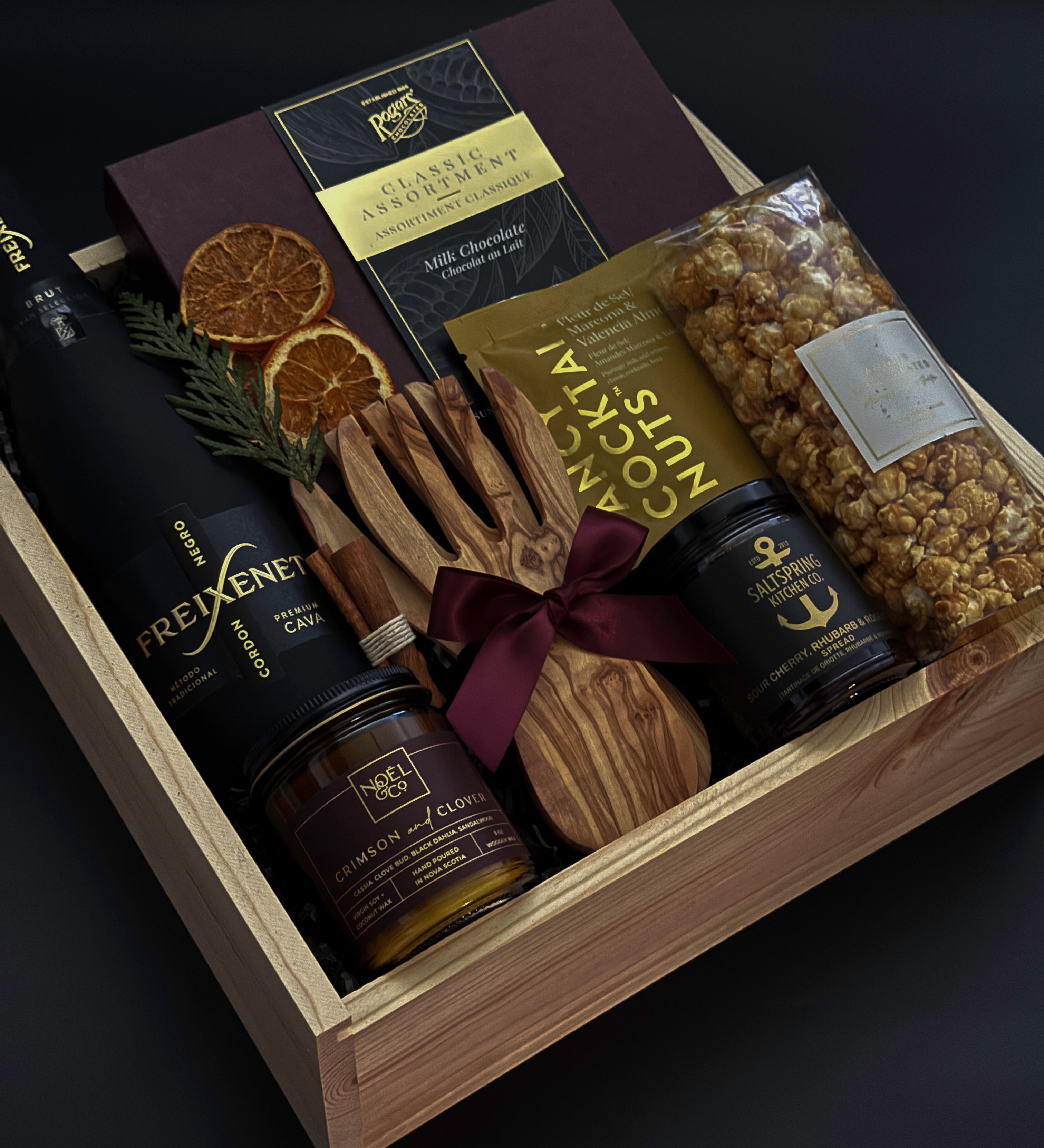 Corporate holiday gift box with sparkling cava, artisan chocolates, and festive accents.