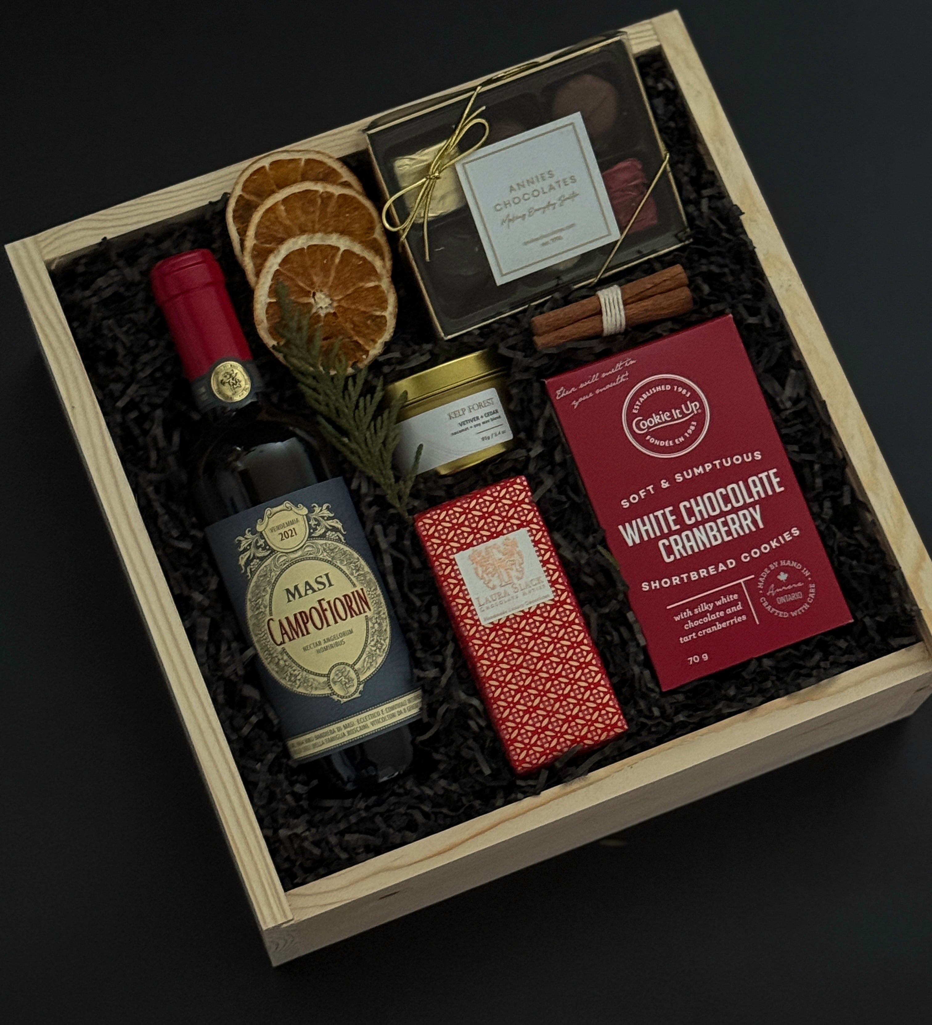 Curated Italian wine and chocolate gift box with festive seasonal details.