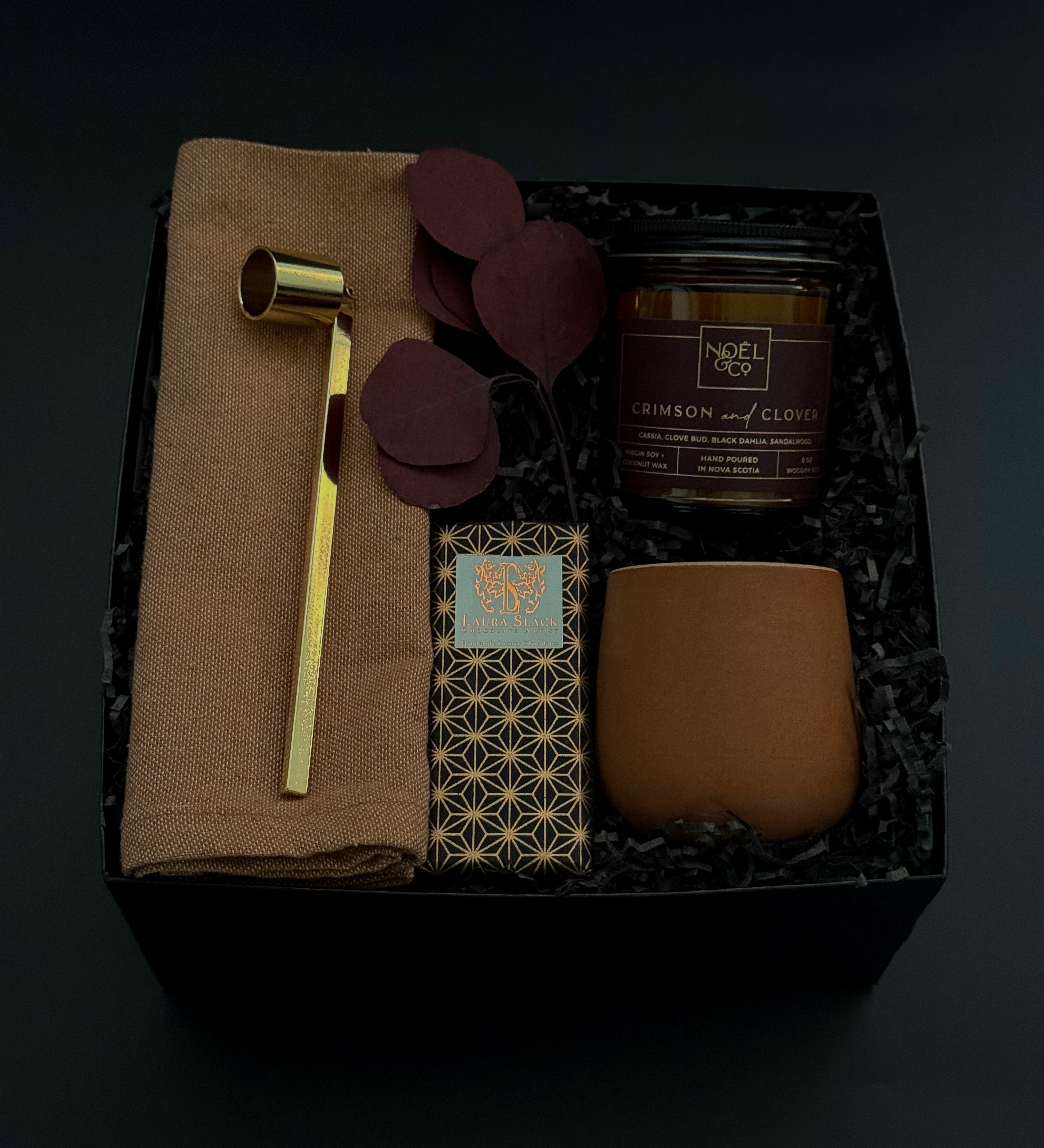 Nocturne holiday gift box with artisan candle, chocolate, stoneware cup, and linen napkin.