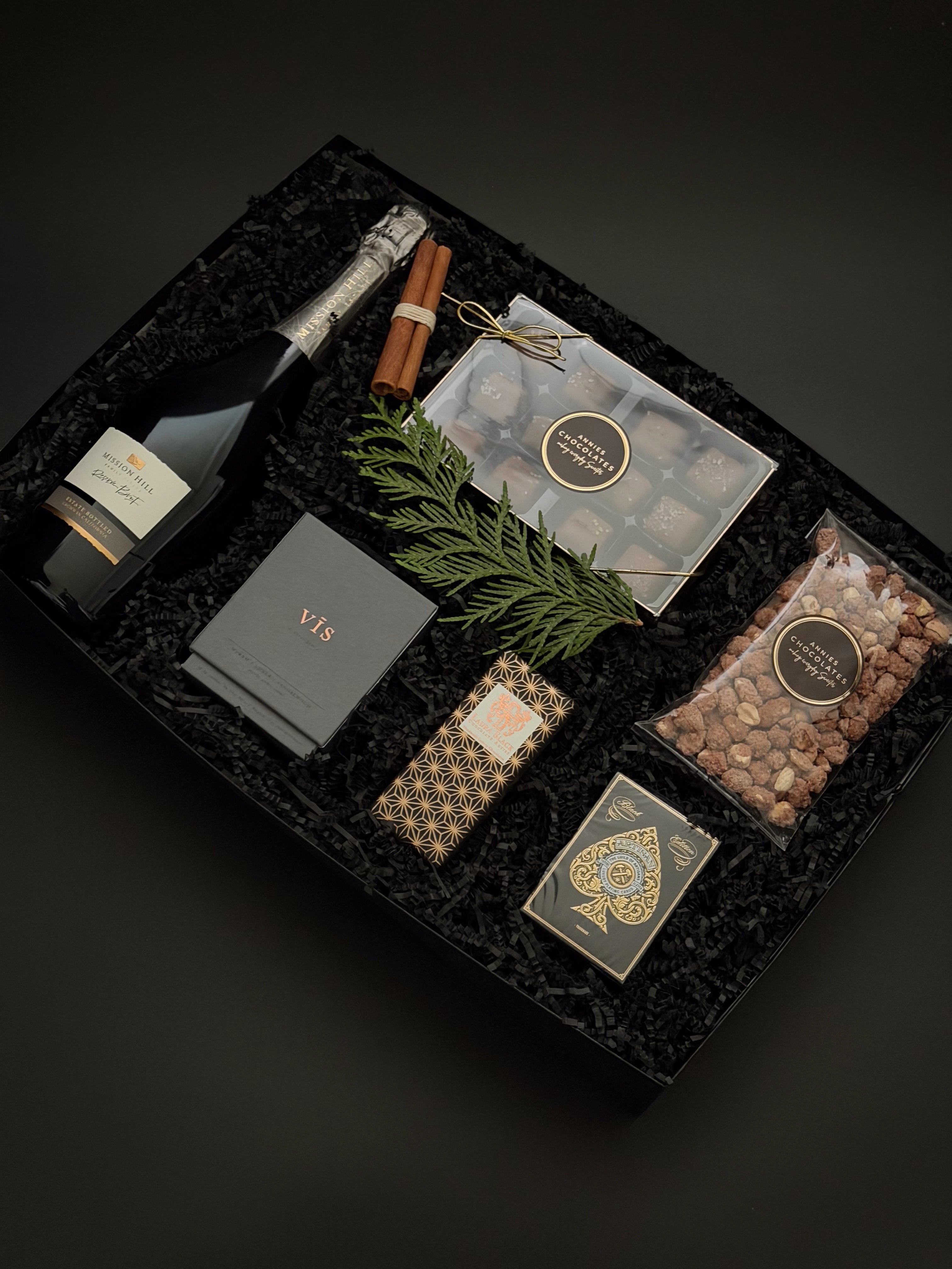 St. James Reserve by Muse Baskets and Co. featuring Annie’s salted caramels, roasted nuts and Theory 11 playing cards in an onyx gift box.