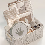 side view of Our Little World baby gift basket with gray animal safari keepsake basket and satin ribbon