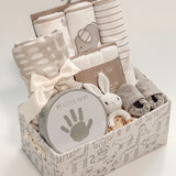 side view of Our Little World baby gift basket with gray animal safari keepsake basket and satin ribbon