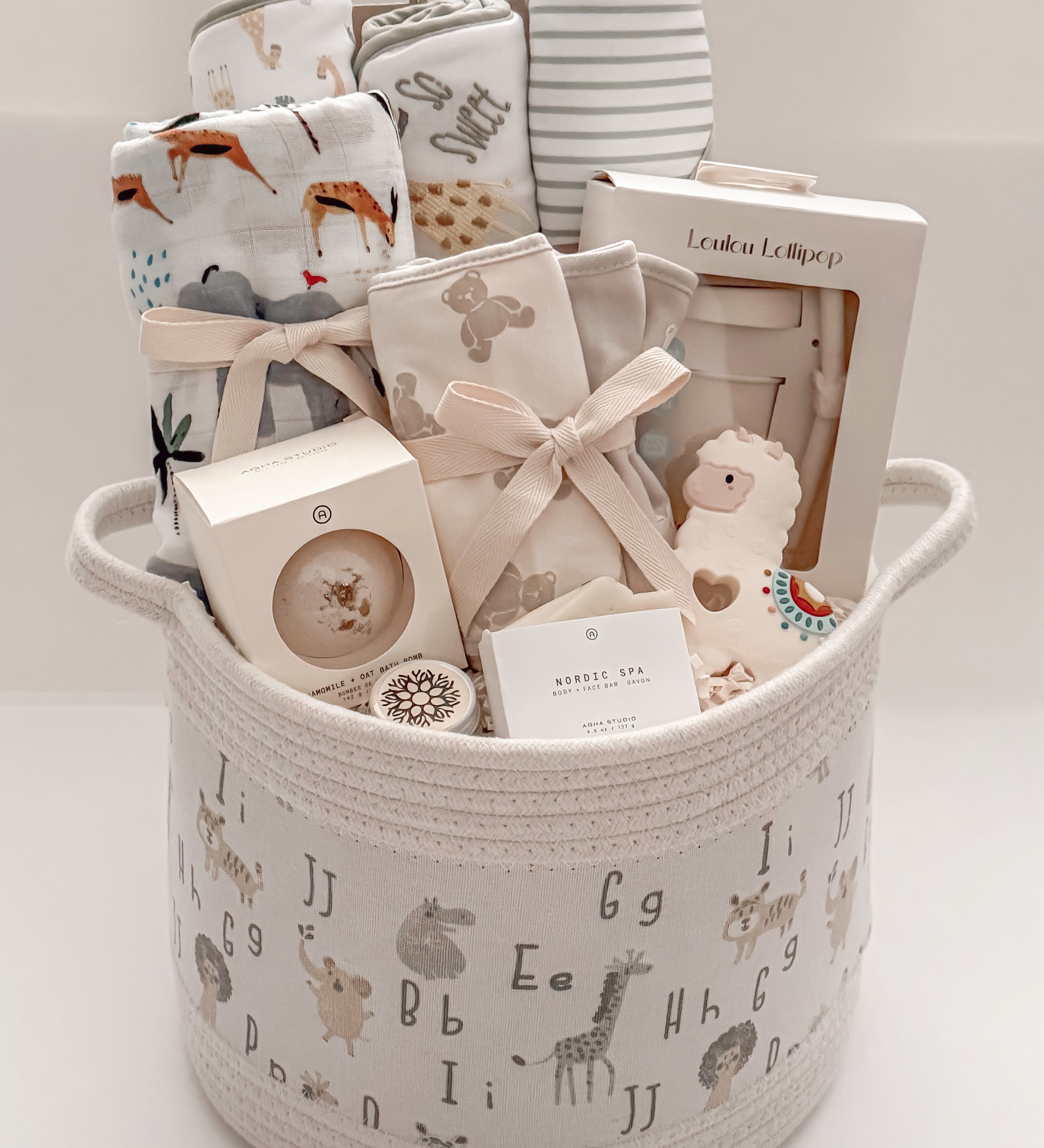 Our Little World gender-neutral baby gift basket with newborn essentials and Canadian-made products