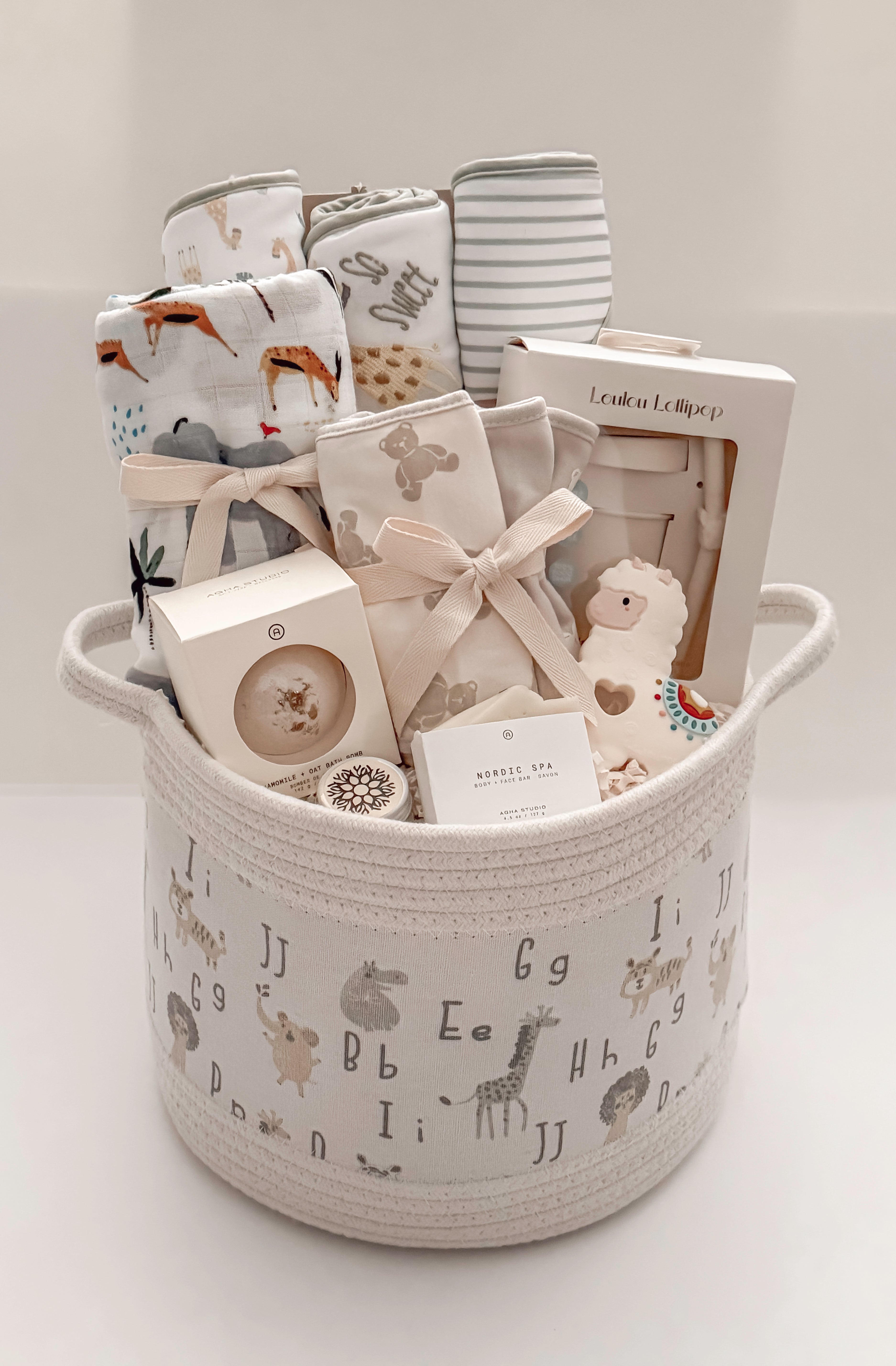 Our Little World gender-neutral baby gift basket with newborn essentials and Canadian-made products