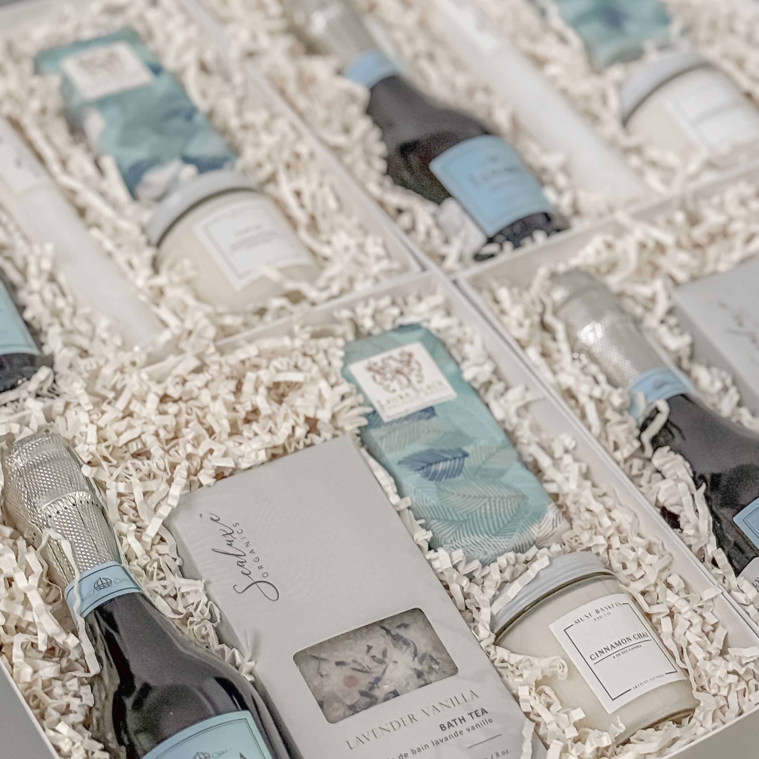 Elegant gift boxes curated by Muse Baskets and Co., featuring La Marca Prosecco, artisan bath tea, gourmet chocolate, and hand-poured candles — ideal for luxury corporate gifting and client appreciation.