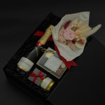Preserved floral bouquet with soft blush tones paired with champagne and chocolates in a luxury gift box