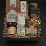 Curated winter tea gift box with chai, cozy socks, artisan chocolate and pretzels by Muse Baskets and Co.