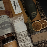 Corporate wellness and appreciation gift featuring tea, socks, and artisan sweets.