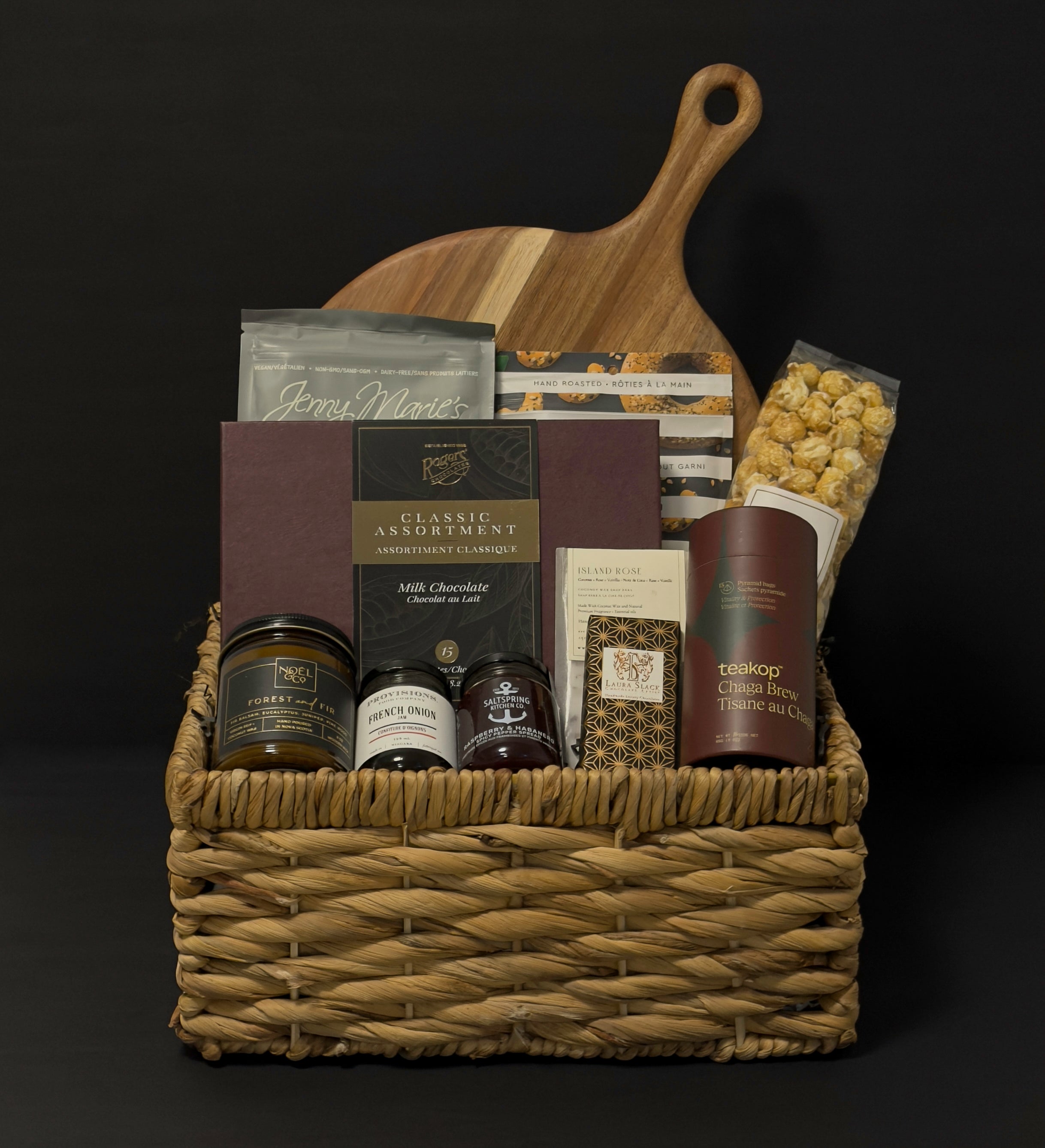 Luxury gourmet gift basket with acacia board, artisan foods, and holiday treats