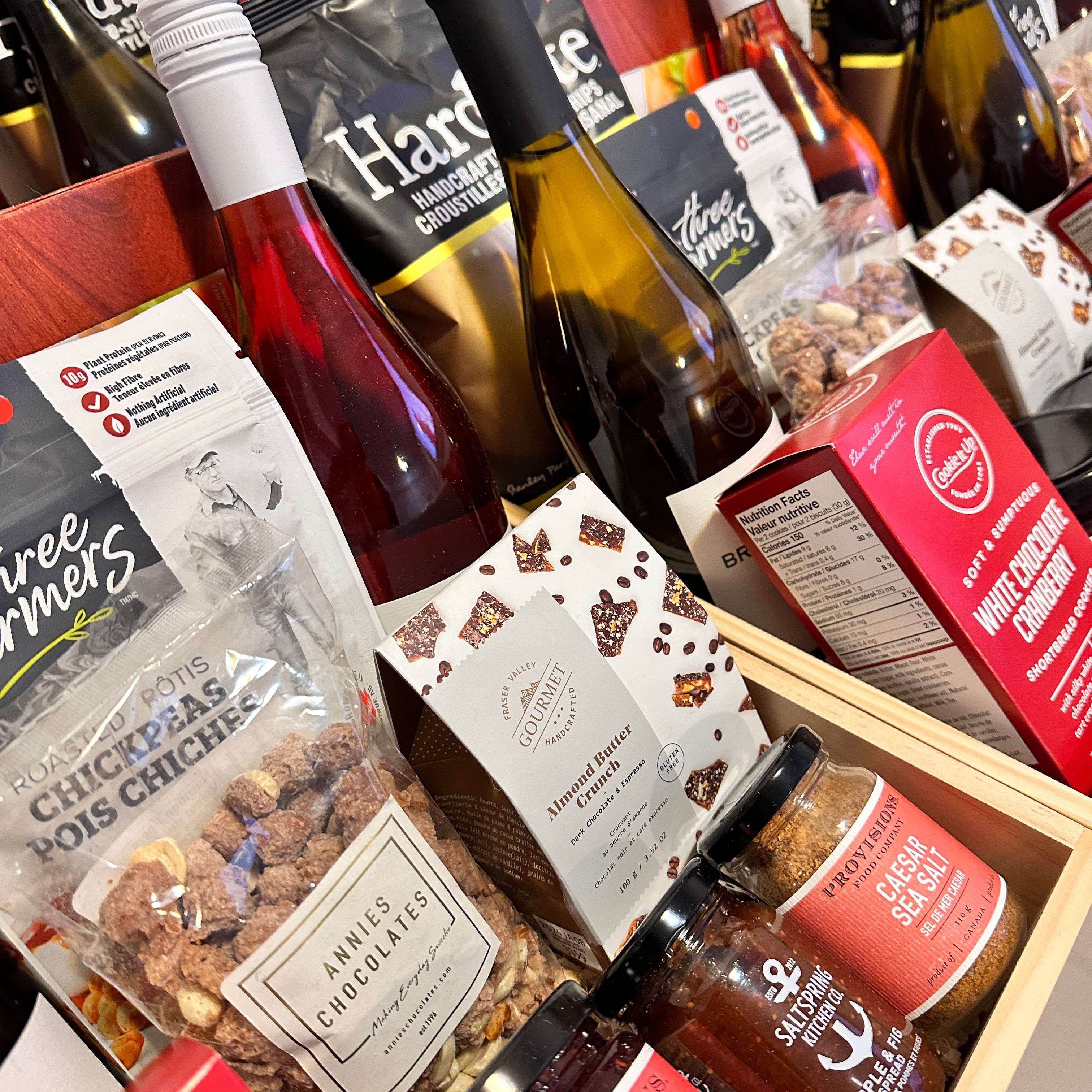 Gourmet gift boxes by Muse Baskets and Co. featuring premium Canadian snacks, artisanal chocolate, wine, and condiments, ideal for corporate gifting, celebrations, and client appreciation.